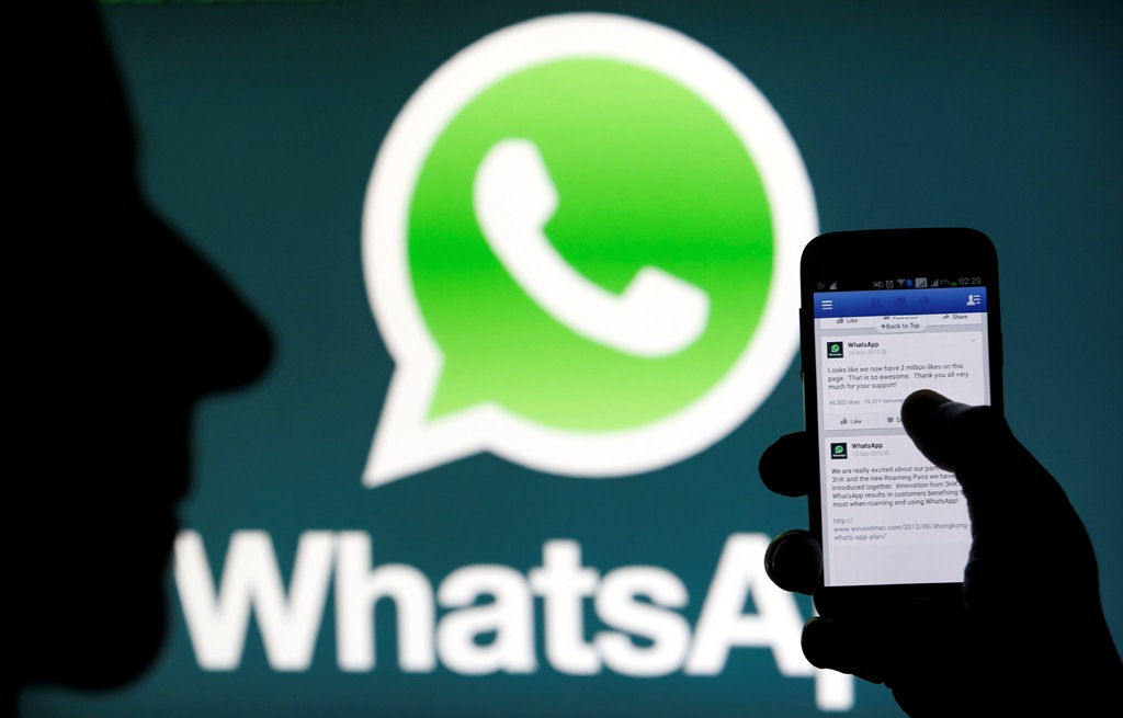 A Whatsapp App logo is seen behind a Samsung Galaxy S4 phone that is logged on to Facebook in the central Bosnian town of Zenica, February 20, 2014. Facebook Inc will buy fast-growing mobile-messaging startup WhatsApp for $19 billion in cash and stock in a landmark deal that places the world's largest social network closer to the heart of mobile communications and may bring younger users into the fold. REUTERS/Dado Ruvic (BOSNIA AND HERZEGOVINA - Tags: BUSINESS)