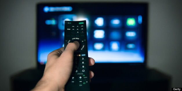 Male hand using Tv remote control