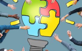 Business People with Light Bulb Jigsaw Symbol