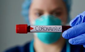 Nurse wearing respirator mask holding a positive blood test result for the new rapidly spreading Coronavirus, originating in Wuhan, China
