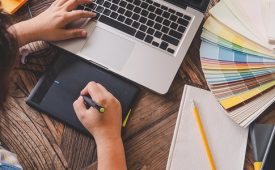 Work of place, designer using electronic pen on board and working on keyboard laptop computer
