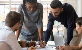Focused multiracial corporate business team people brainstorm on paperwork