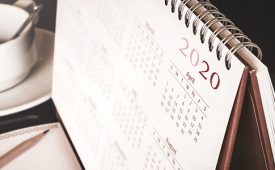 Desktop calendar sitting on desk showing year of 2020
