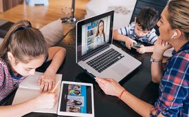 Mother trying to talk with doctor on laptop while watching two kids staying home. Homeschooling and distance learning