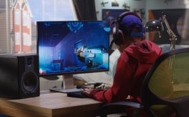 Medium shot of a boy playing with a first-person shooter video game
