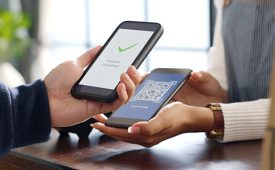 Customer using phone for payment at cafe restaurant, cashless QR code technology and money transfer concept