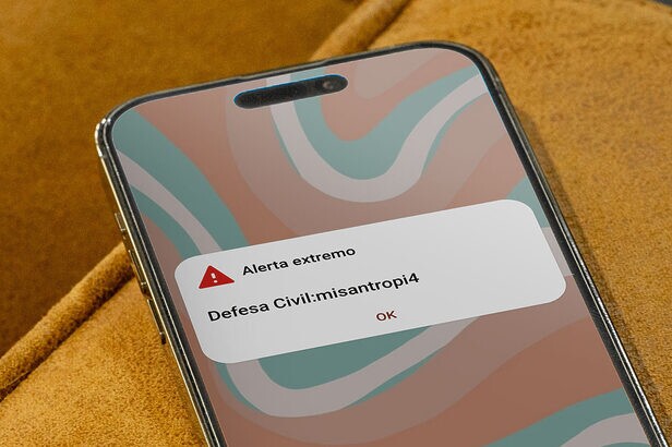 Smartphone exibe notificação de alerta extremo da Defesa Civil com a mensagem "misanthropi4".